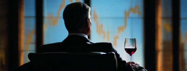 Enthusias An investor sitting in front of a glass of red wine b7ed6b8a 23e5 4fbc a6c4 cb803d797ad7 3