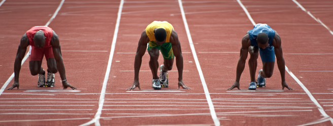 Enthusias Three Caucasian 100 meter sprinters on a tartan tra 34c81f6d 6a63 4740 9823 eae5af97fdd4 1