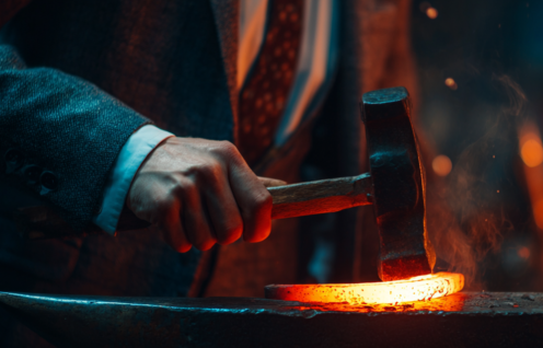 Enthusias A man in a business suit forging a still glowing ho 79450a3d 5364 4222 9fd7 82646d3fe8c8 1