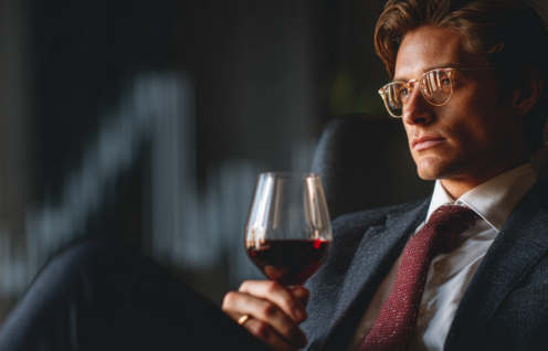 Enthusias An investor sitting in front of a glass of red wine a012d53d 3cad 4567 94e7 8d412e0f4ebb 0