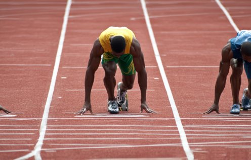 Enthusias Three Caucasian 100 meter sprinters on a tartan tra 34c81f6d 6a63 4740 9823 eae5af97fdd4 1